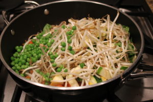 adding sprouts and peas